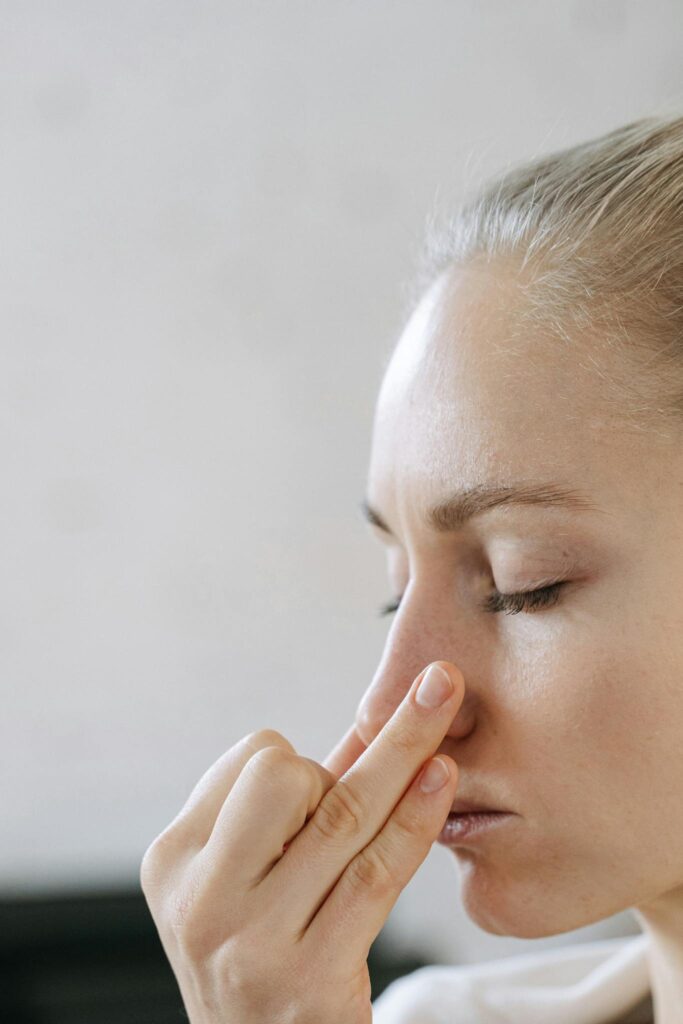 Close-up of a woman practicing mindful breathing, enhancing relaxation and wellness.